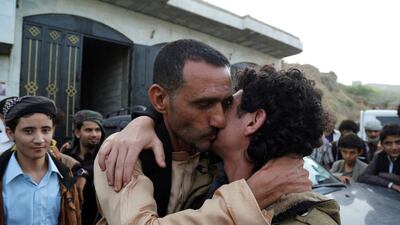 A man hugs his son after his release with other pro-government fighters in a prisoner swap between Yemeni forces and Houthis in Taez in central Yemen n June 18, 2016. REUTERS/Stringer