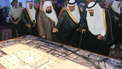 Saudi Arabia's King Abdullah, right, looks at a model of the Prophet's Mosque during the laying of the foundation stone ceremony for its development and expansion. Amer Hilabi / AFP Photo