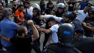 Hezbollah supporters, right, clash with anti-government protesters, left, in Beirut. AP