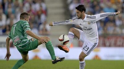 Real Madrid's Isco, right, tries to control the ball against Cornella's Pep Caballe during their Copa del Rey match on Wednesday. Josep Lago / AFP / October 29, 2014