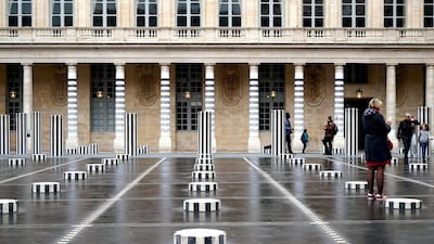 Art by French street artist Le MoDuLe De ZeeR aka LMDZ installed on the columns of the Palais Royal in Paris, facing the Colonnes de Buren by French artist Daniel Buren. AFP