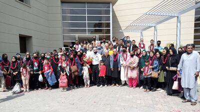 Members of the Afghan women's football team along with their families pose for a group photo upon their arrival at the Pakistan Football Federation in Lahore. Reuters