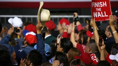 A supporter holds a placard as Donald Trump speaks during the rally. Reuters