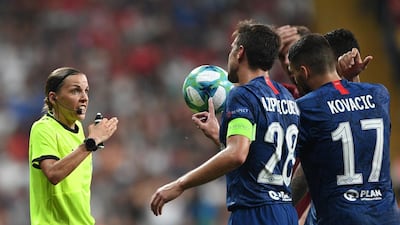 French referee Stephanie Frappart speaks with Chelsea's players during the UEFA Super Cup. AFP