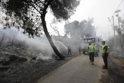 Firefighters extinguish flames in a forest near the village of Meshref in Lebanon's Chouf mountains, southeast of the capital Beirut, on October 15, 2019. AFP