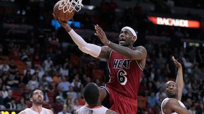 Miami's LeBron James drives against Byron Mullens, Ben Gordon and Kemba Walker of the Charlotte Bobcats.