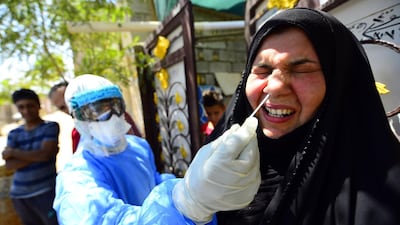 An Iraqi medic swabs a woman in Iraq's central city of Najaf, during the nationwide lockdown to stem the spread of the novel coronavirus. AFP