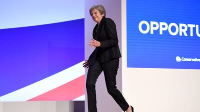 Ms May throws a few dance moves as she walks on to the stage to deliver her leader's speech during the 2018 Conservative Party Conference in Birmingham