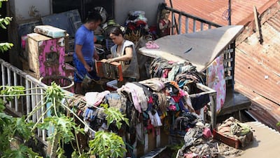 Residents try to salvage belongings in Talisay. AP