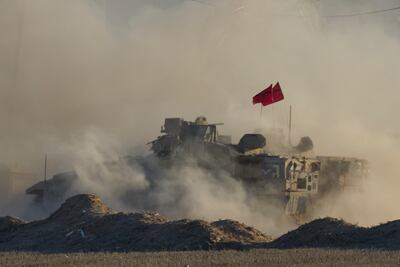 An Israeli armoured vehicle moves near the border of the Gaza Strip in southern Israel. AP