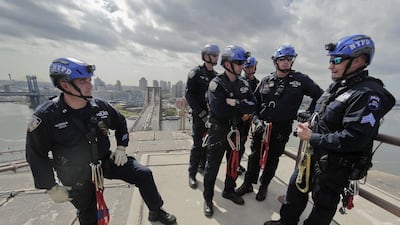 New York Police sergeant John Flynn, right, briefs officers during a training exercise. To join the unit, candidates must have at least five years on patrol and make it through an eight-month training programme followed by rigorous testing. Julie Jacobson / AP Photo