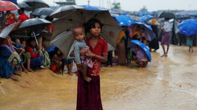 Rohingya refugees queue in the rain to receive food at Kotupalang refugee camp near Cox's Bazar, Bangladesh October 20, 2017. Jorge Silva / Reuters