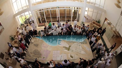 Chinese investors listen look at a model of a dry dock which is to be built in the Omani port city of Duqm, on May 24, 2016. Mohamed Majoub / AFP