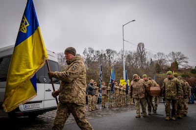 Servicemen carry the coffin of volunteer soldier Yukhym Agafontsev, 22, killed in a battle with Russian troops, during a farewell ceremony in Kyiv on Tuesday. AP