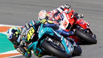 Valentino Rossi, left, steers his motorbike during his last professional race in Valencia. EPA