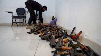 A member of the Syrian security forces places weapons in a room after they were collected in the northern city of Raqqa. Reuters