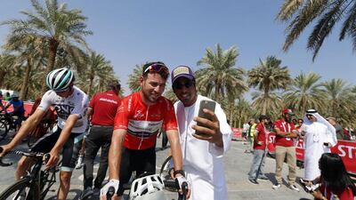 Mark Cavendish poses for a picture with a fan before Stage 3. Karim Sahib / AFP