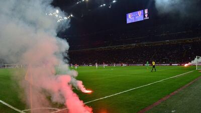 Flares thrown by Croatia fans burn on the field during the Euro 2016 qualifying match between Italy and Croatia at the San Siro in Milan on Sunday. Giuseppe Cacace / AFP