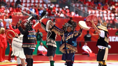 Performers on the pitch ahead of the match. Reuters