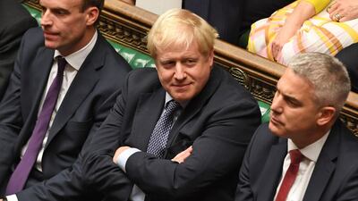 A handout picture released by the UK Parliament shows Britain's Prime Minister Boris Johnson (C) smiling in the House of Commons in London on October 19, 2019, AFP
