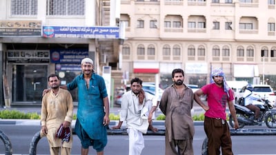 Dhow loaders gather by the creek in Deira. The creek has been a hub of activity for decades with traders bringing in goods and selling their wares at the bustling markets nearby. Reem Mohammed / The National