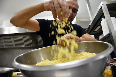 Algerian chef Rabah Ourrad prepares a couscous dish in Algiers on December 13, 2020. AFP