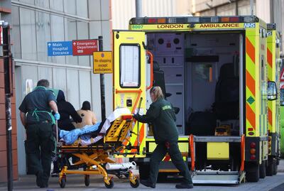 Paramedics take a patient from an ambulance into the Royal London Hospital. Reuters