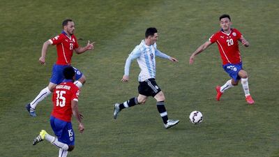 Argentina's Lionel Messi dribbles through Jean Beausejour, No 15, Marcelo Diaz, left and Charles Aranguiz, right, of Chile during the Copa America final on Saturday. Uselei Marcelino / Reuters