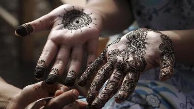 Readers warn that some henna treatments can have bad side effects. (AP Photo/Fareed Khan)