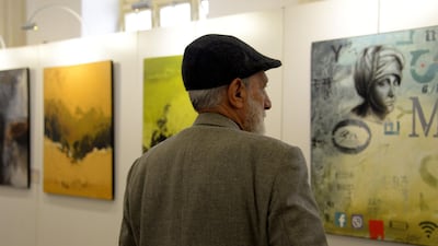 Visitors walked through the hall to look at the paintings and sculptures, many of which feature themes of home, return, or conflict. AFP