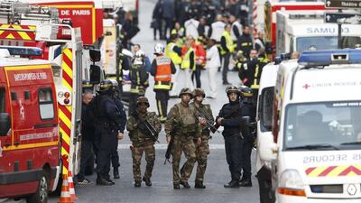 French riot police (CRS), soldiers, firefighters, French red cross members and staff of the emergency medical services in France (SAMU) stand at the scene in Saint-Denis, France. Benoit Tessier / Reuters
