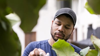 Oscar Murillo works on his installation. Reem Mohammed / The National