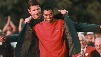 In this April 13, 1997 file photo, Masters champion Tiger Woods receives his Green Jacket from Nick Faldo at the Augusta National Golf Club in Augusta, Ga. Woods won the Masters by 12 shots, at the time the largest margin of victory in any major since the 1899 U.S. Open. (AP Photo/Dave Martin, file)