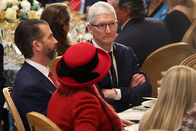Apple's Tim Cook sits next to Donald Trump, Jr, at the inaugural luncheon for US President Donald Trump. Getty Images