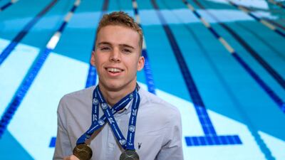 Lewis Burras, a sixth-form pupil at JESS School Dubai, shows off his medals from the recently concluded British Swimming Championships. Victor Besa / The National