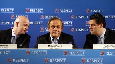 Left to right: Uefa general secretary Gianni Infantino, UEFA president Michel Platini and UEFA chief of press Pedro Pinto speak during a pres conference on the eve of the qualifying draw Euro 2016, on February 22, 2014 in Nice, southeatern France. AFP PHOTO / VALERY HACHE