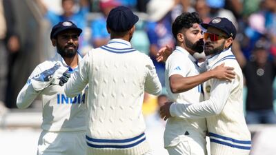 India's Mohammed Siraj, second right, celebrates after taking the wicket of Australia's Travis Head. AP
