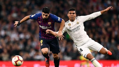 Luis Suarez vies with Real Madrid's midfielder Casemiro. AFP