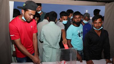 Labourers entering their names for the raffle draw.