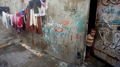 A Palestinian boy looks out of his family's house in Al-Shati refugee camp in Gaza City. Mohammed Salem / Reuters