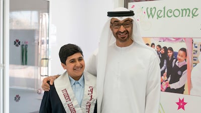 Sheikh Mohammed bin Zayed Al Nahyan, stands for a photograph with a student, during a visit to Hamdan bin Zayed School. Hamad Al Kaabi / Crown Prince Court - Abu Dhabi