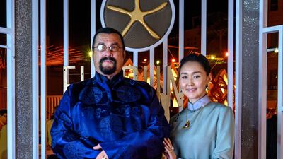 US actor Steven Seagal poses with his wife Erdenetuya on the red carpet during the closing ceremony of the El Gouna Film Festival. AFP