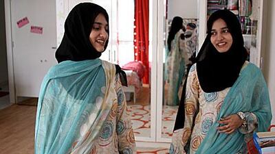 Fatima Masood, left, and her twin sister Mariam, seen in the room they share, have yet to receive sales figures for their book.