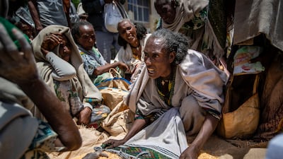 A woman argues over the allocation of yellow split peas in the Tigray region of northern Ethiopia. AP