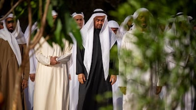 Sheikh Mohamed prays during the iftar reception
