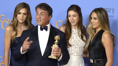 US actor Sylvester Stallone is accompanied by his daughters as he holds the award for Best Supporting Performance in a Motion Picture for Creed. Paul Buck / EPA
