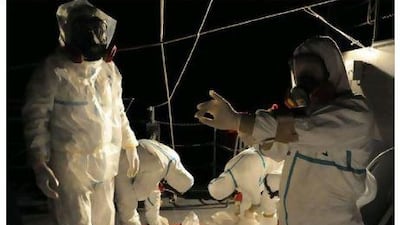 Japan Maritime Self-Defence Force personnel operate on the force's auxiliary multipurpose support ship Hiuchi near the Tokyo Electric Power Company's Fukushima nuclear power plant.
