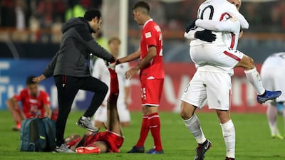 Kashima Antlers players celebrate after the winning the Asian Champions League final as Persepolis players are consoled. Getty Images