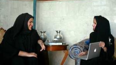Hyam al Mureikhei, right, a graphic designer, chats at her home with her friend Salama al Shamsi, an interior designer. Both in their twenties, they value their heritage and hope to preserve it.