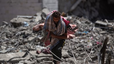 A Palestinian man inspects the damage after the withdrawal of Israeli forces from Hamad City in Khan Younis, southern Gaza Strip, on August 24. EPA /